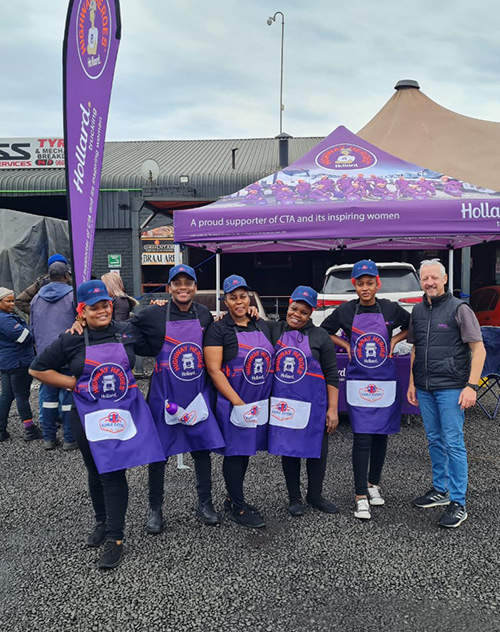 Hollard representatives wearing branded bibs gathered for a photo.