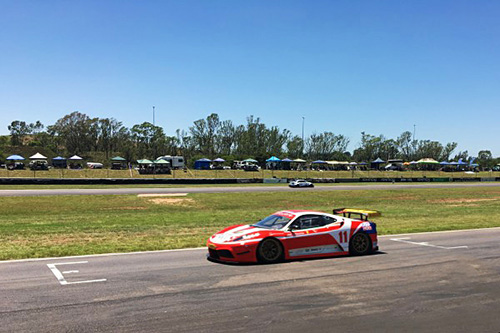 Bright red Ferrari 360 Challenge Stradale hurtling down the straight at Zwartkops Raceway.