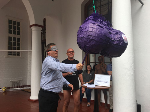 A blindfolded volunteer beating a testicle piñata